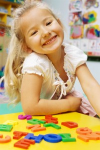 Portrait of a girl smiling in a classroom